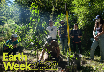 photo of volunteers planting a tree in honor of earth week