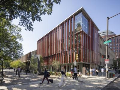 renovated graduate school of education and passerby on sidewalk